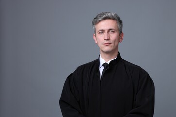 Judge in court dress on grey background. Space for text