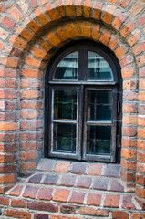Old window in brick wall in Vilnius Old Town