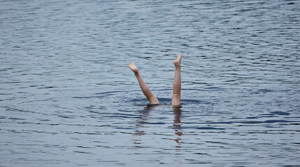Feet First Dive in a Rippling Lake
