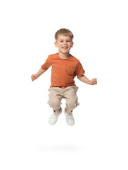 Happy little boy dancing on white background