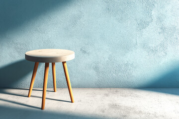 Minimal round stool casting shadow on textured pastel blue wall
