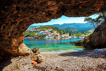 Beautiful landscape with bay and colorful buildings on the background of picturesque clouds in the town of Asos, Greece, Kefalonia. Wonderful exciting places.