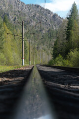 Railway in the mountains. Vertical photo.