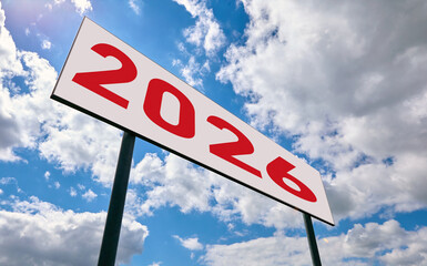 Bold sign displaying the year 2026 against a vibrant blue sky with scattered clouds in the...