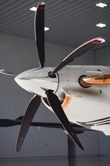 Detailed side angle view of a turboprop aircraft nose and propeller, showing polished spinner,...