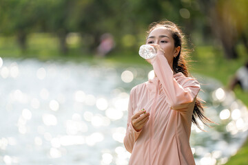 woman running in the park. Young smiling sporty woman running in park in the morning. Fitness girl...