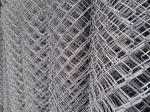 metal galvanized fence nets. roll of metal net in warehouse. Steel net cage for construction.rolls of wire mesh in the showroom