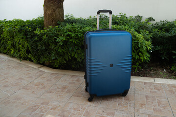 Travel suitcase outdoors. Tourism and summer vacation concept.