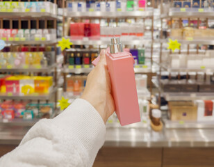  buying make up at cosmetics section in store. choosing cosmetics, perfumes, creams and shampoos, Using tester.