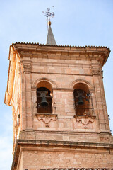 Bell tower of Santa Maria Del Salvador church under blue sky in The old town of Chinchilla de Montearagon