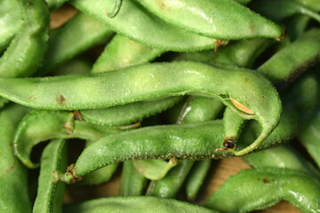 Group Of Fresh Hyacinth Bean or Same Ki Phalli On Wooden Table Close Up With Background Blur