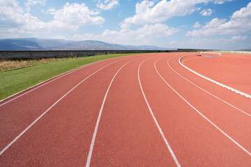 Empty athlete track or running track with blue sky.