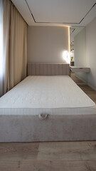 new bed with white mattress in new apartment