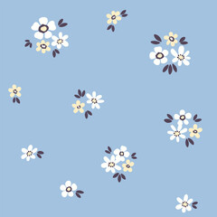 Seamless floral pattern, liberty ditsy print of pretty daisies in mini bouquets on blue. Cute botanical design of small hand drawn flowers, tiny leaves.  Simple textile fashion. Vector illustration.