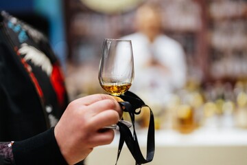 Savoring the rich aroma of whiskey in a bustling distillery event
