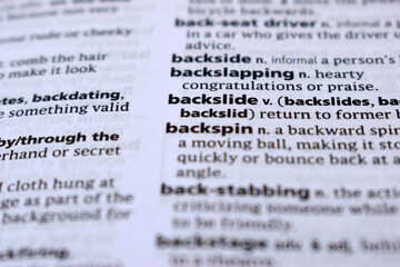 Close Up Of English Dictionary Page With Definition Word -Backslide