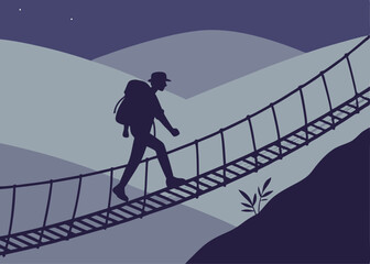 Silhouette of a Hiker Crossing a Rope Bridge with Mountains in the Background