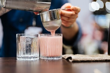 Crafting a refreshing beverage with skill and precision at a bustling bar