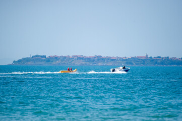 Obraz premium banana boating in the sea in Bulgaria with Nesebar on background