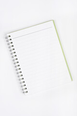 An open spiral-bound notebook with blank lined pages on a white background