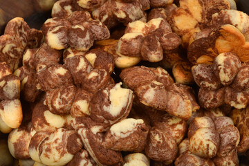 A close-up shot of a pile of marble-patterned cookies in brown and light colors