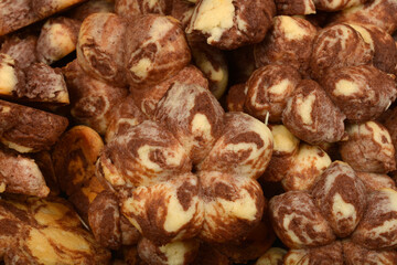 A close-up shot of a pile of marble-patterned cookies in brown and light colors