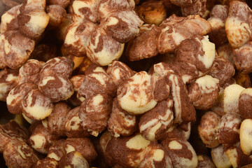 A close-up shot of a pile of marble-patterned cookies in brown and light colors