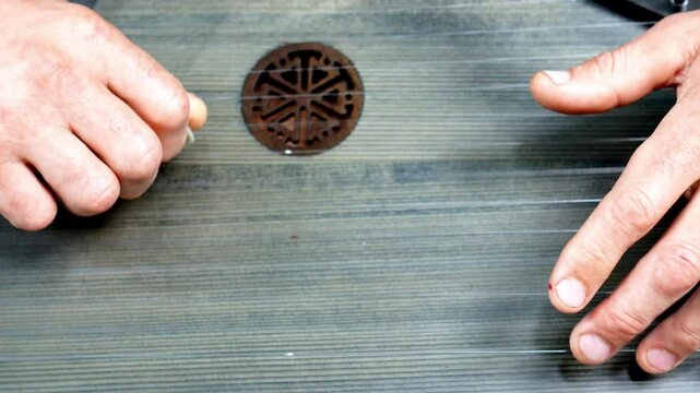 Male musician's hands playing the strings of a wooden vintage gusli close-up as a folk instrument playing concept