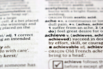 Close Up Of English Dictionary Page With Definition Word - Achieve