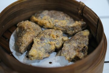 Gohyong or Ngo Hiang, made from minced chicken with flour wrap, served on bamboo bowl