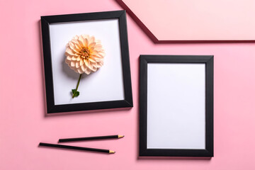 Frame mockup with flower and pencils on pink background flat lay