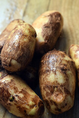 Group Of Taro Root Vegetable On Wooden Table Close Up