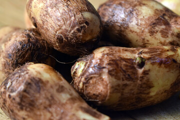 Group Of Taro Root Vegetable On Wooden Table Close Up