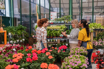 Florist and customers interacting in a greenhouse