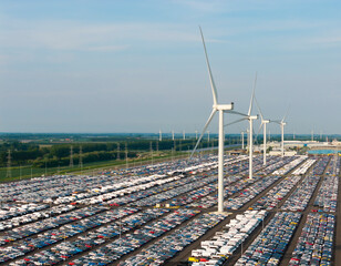 Aerial view of wind turbines and parked cars at a harbour storage in the Netherlands