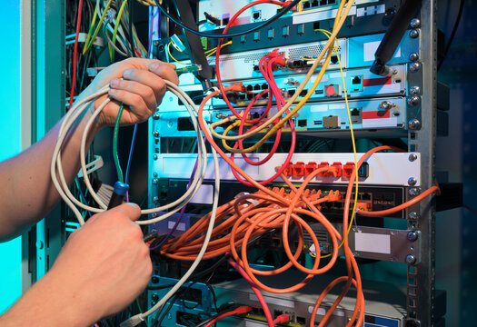 IT professional managing network cables in a server room