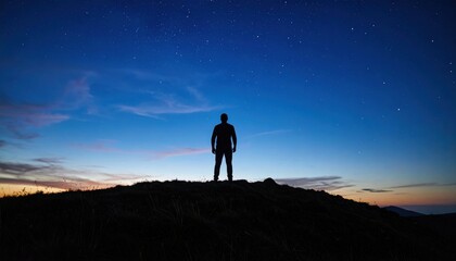 Silhouette of Person on Hilltop at Sunrise