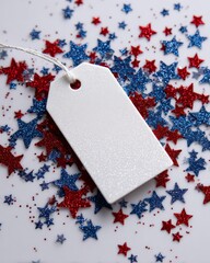 A blank white gift tag surrounded by red and blue glittery stars on a white background. 4th of July sale, Independence day in United States of America celebration