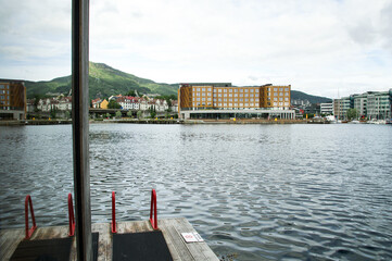 Modern waterfront architecture with colorful reflections in Norway, showing buildings and calm...