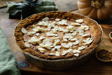 Pumpkin pie sprinkled with sliced almonds. Thanksgiving food.