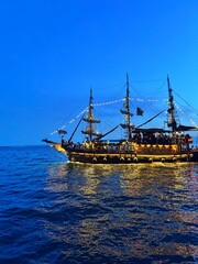 Small illuminated cruise ship at sea, Greece