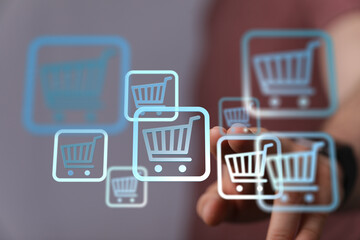 Person interacting with digital shopping cart icons, representing online shopping and e-commerce.