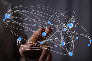 Abstract image of a hand interacting with a complex network of interconnected nodes, representing...