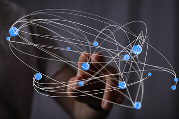 Abstract image of a hand interacting with a complex network of interconnected nodes, representing global communication or data flow.