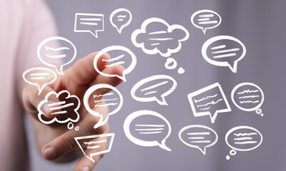 Abstract image of hand interacting with digital speech bubbles, representing communication, social media, and networking.