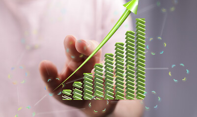 Stock photo of a hand interacting with a 3D bar graph, illustrating growth and progress.
