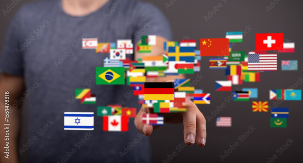 Poster A man interacts with a digital display of world flags, symbolizing global connection and communication.