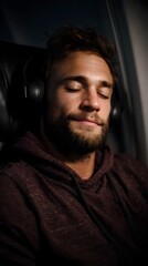Obraz premium Sleeping passenger wearing headphones during flight