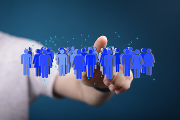 Image depicting a hand interacting with a digital network of people, symbolizing global connection...
