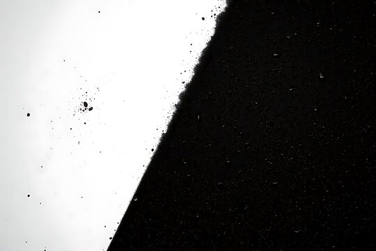 Abstract black and white diagonal split with splatter and droplets